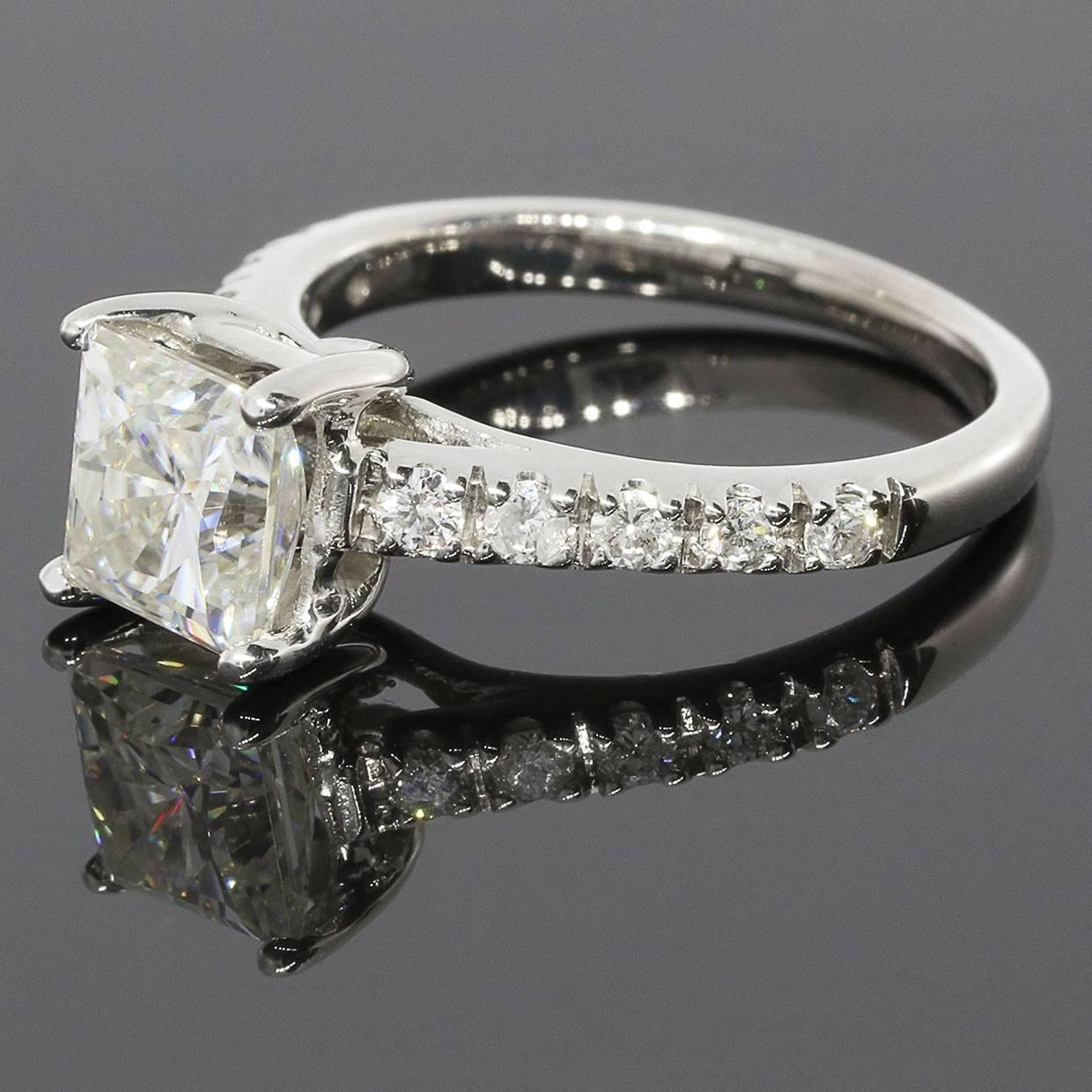 This stunning engagement ring features a beautiful 1.50 carat, 6.5 millimeter, princess cut Moissanite center stone. This Moissanite is a Charles & Colvard Forever Brilliant gemstone. Moissanites are an excellent choice for engagement rings.