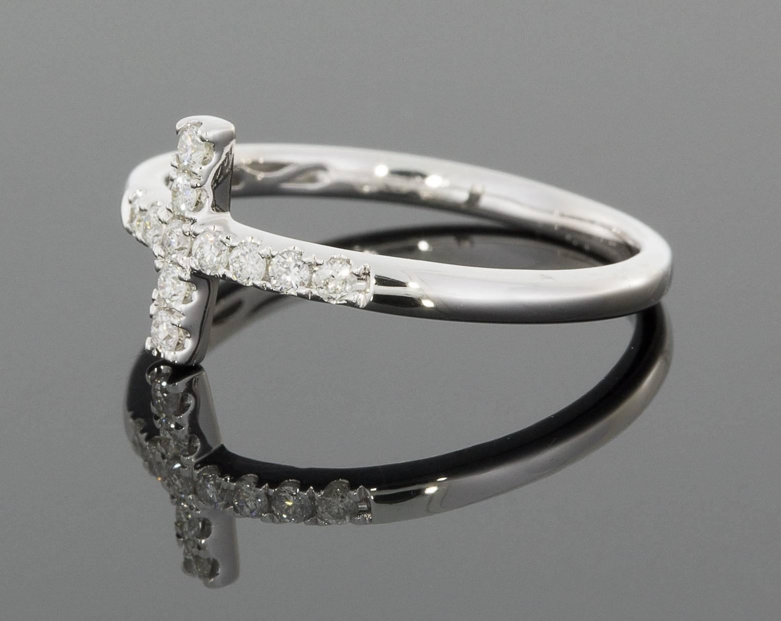 Show your faith with this beautiful diamond cross ring! The ring can be worn normally or as a midi ring, one of the hottest trends in jewelry meant to be worn in the middle of the finger between the knuckles. This lovely ring features a traditional
