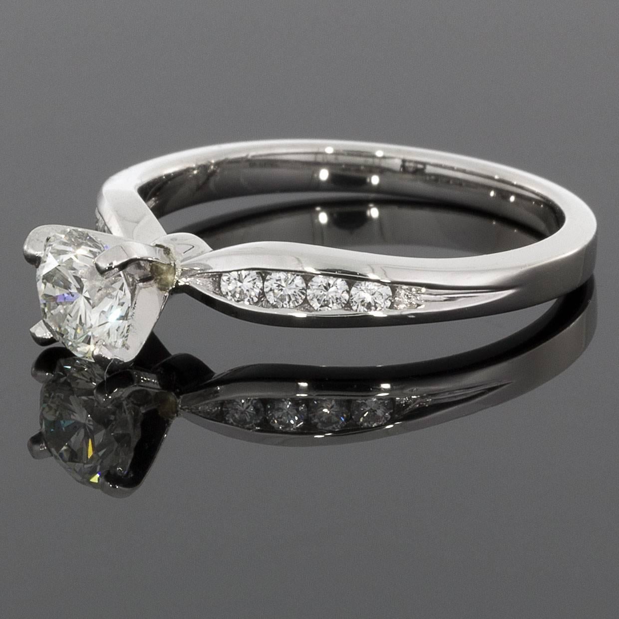 This beautiful, classically styled engagement ring features sparkly, round brilliant cut diamonds. The center diamond is a lovely, .54 carat round brilliant cut that grades as I/SI2 in quality (near colorless & flawless to the naked eye). It is