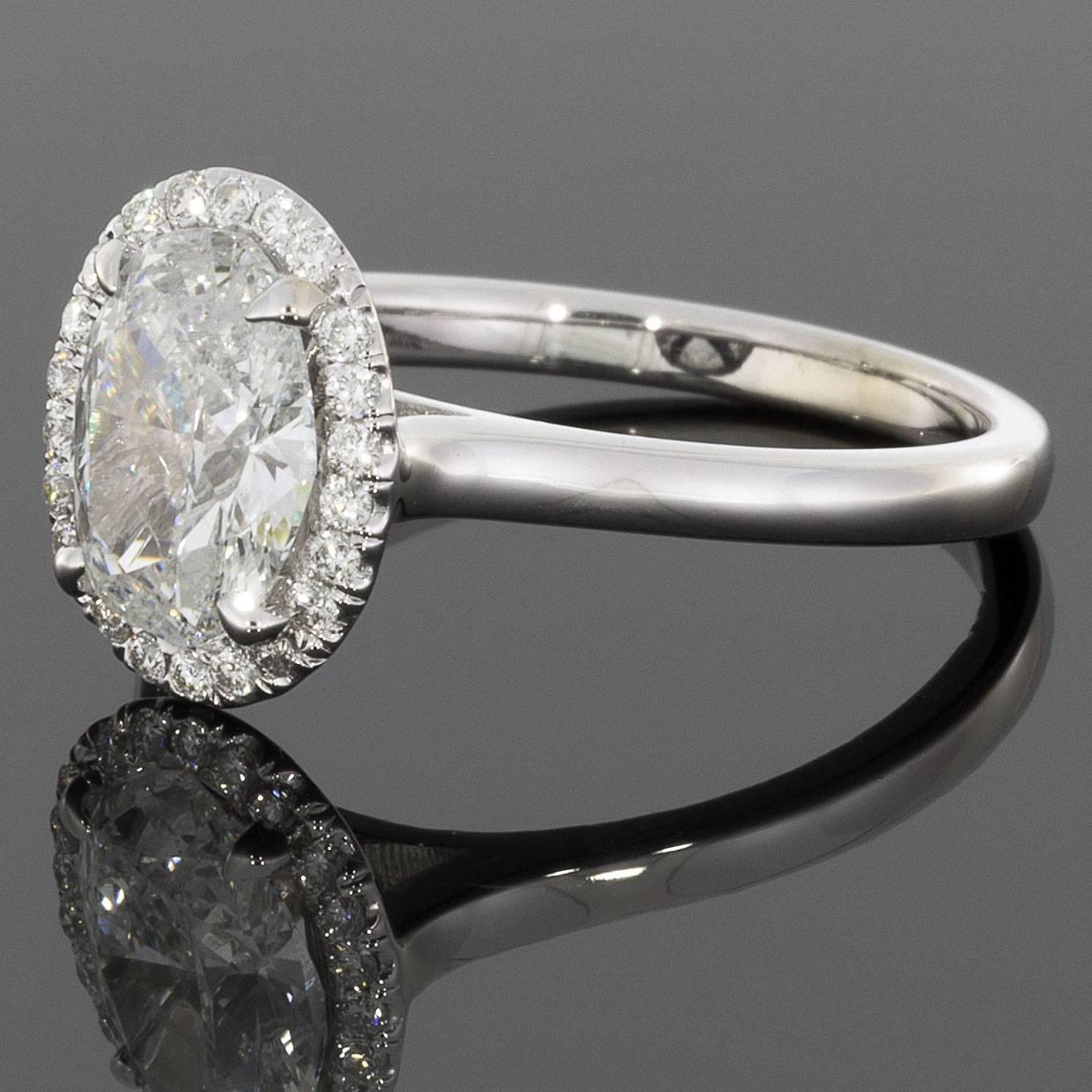 This stunning diamond ring is simply breathtaking! The center diamond is a 1.40 carat, oval brilliant cut diamond that is GIA certified as F/I1 in quality. This beautiful, colorless diamond is prong set in a white gold ring that was custom made to