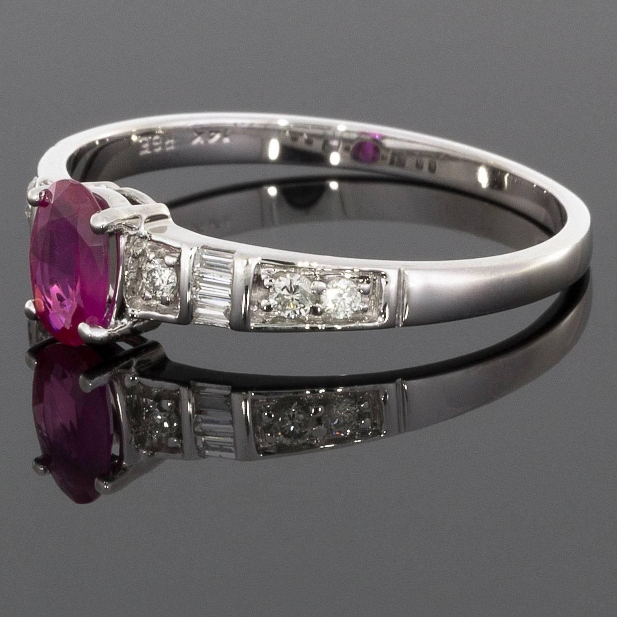 This luscious ruby ring has a beautiful art deco style that gives a really timeless & elegant look! The ring features an oval cut, natural, ruby center. The ring's shoulders are accented with round brilliant & baguette cut diamonds. The ring