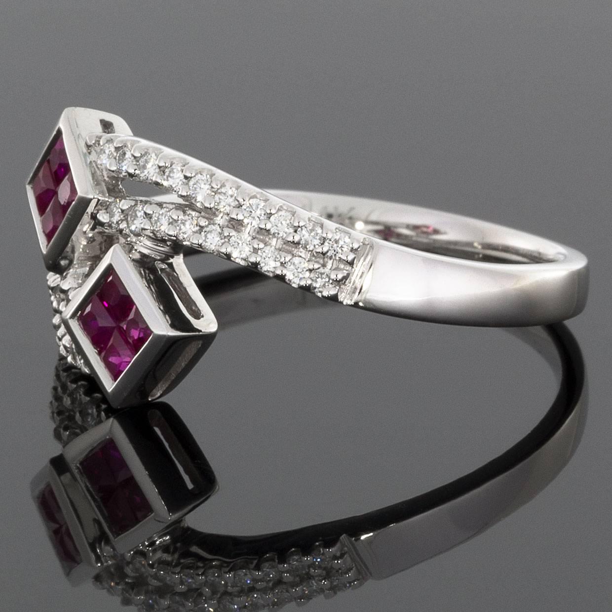 This beautiful ruby ring is perfect for dressing up any outfit! It features a beautiful & playful split shank, bypass design that resembles shooting stars. 8 natural, princess cut rubies are illusion set in 2 square shapes. The shank of the ring