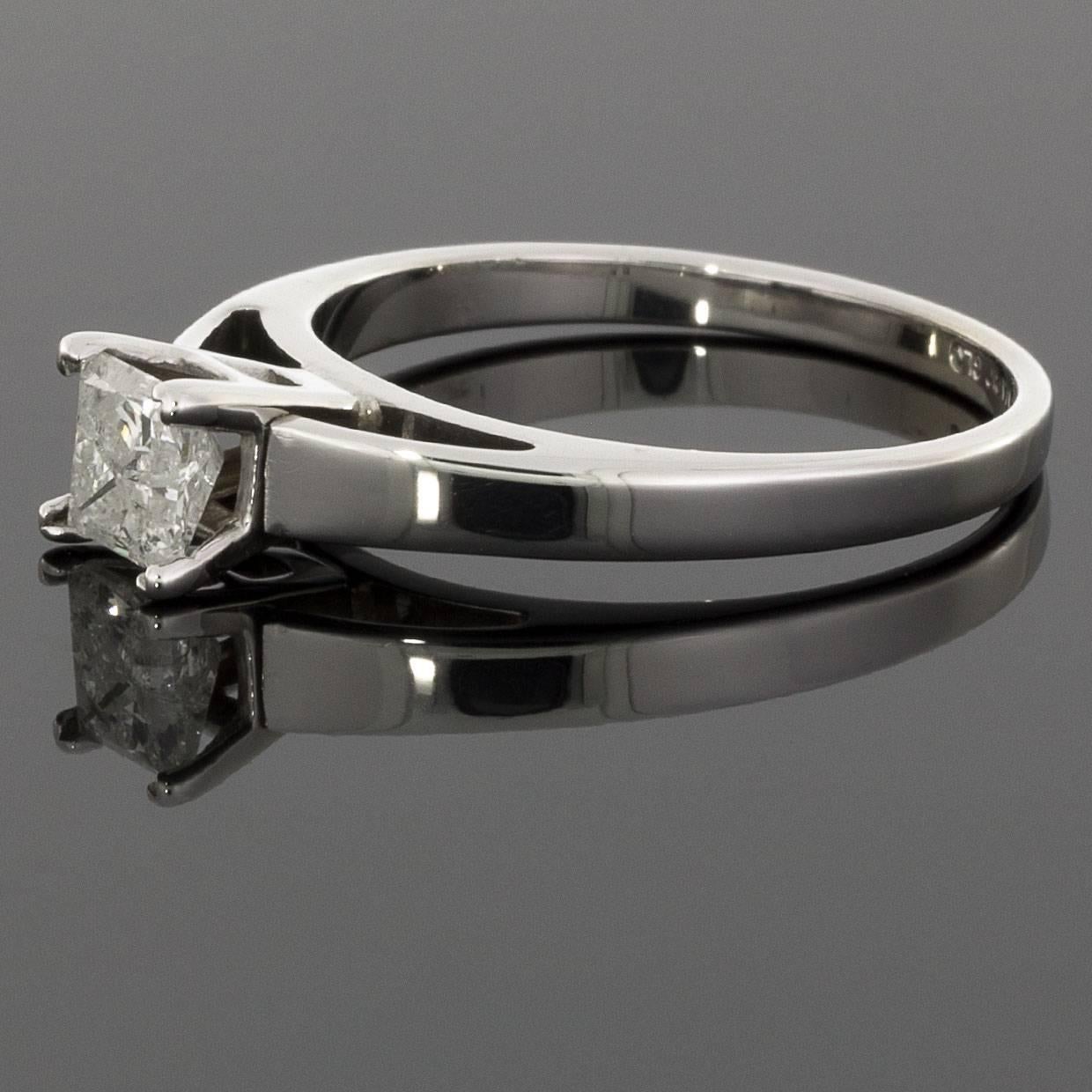 This beautiful diamond engagement ring features a princess or square brilliant cut diamond center. This diamond weighs .52 carat & grades as I/I1 in quality. It is 4-prong set in a 14 karat, white gold solitaire setting. The classic, timeless