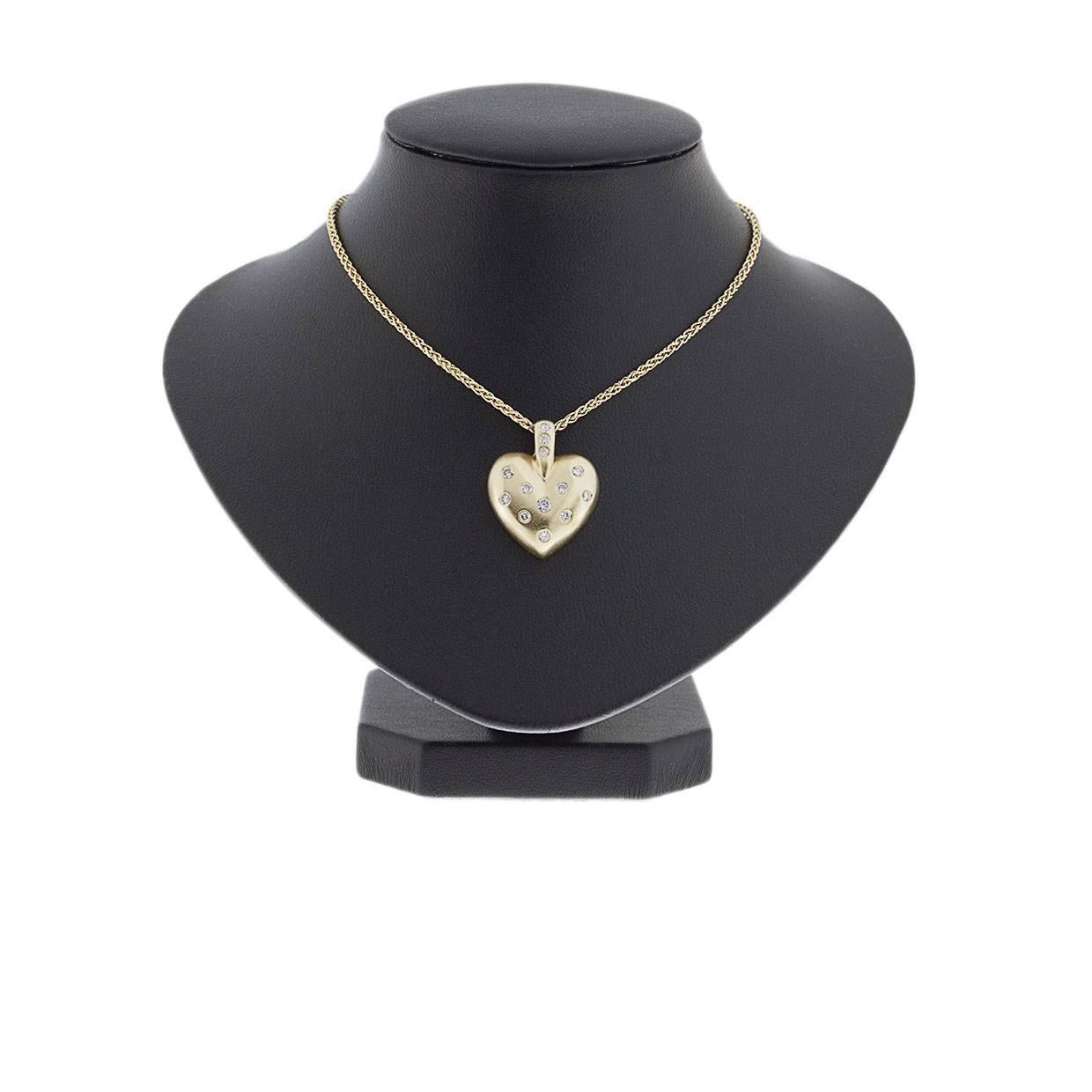 This lovely pendant gives a classic, elegant look with its understated sparkle. It features 13 round brilliant cut diamonds that have a combined total weight of .40 carat. These sparkly & beautiful diamonds are flush set in a 14 karat yellow gold,