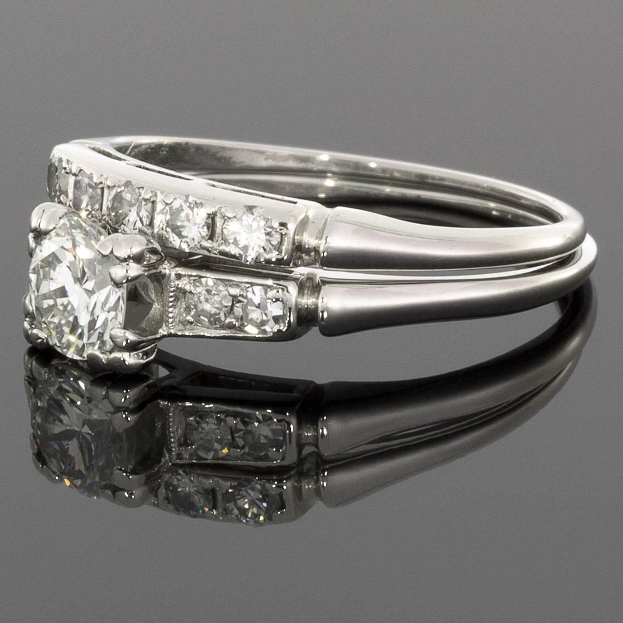 This gorgeous vintage engagement ring & wedding band set gives an elegant, timeless look. The set is comprised of platinum & features a scintillating, .45 carat round brilliant cut center diamond. This diamond grades as H/VS1 in quality
