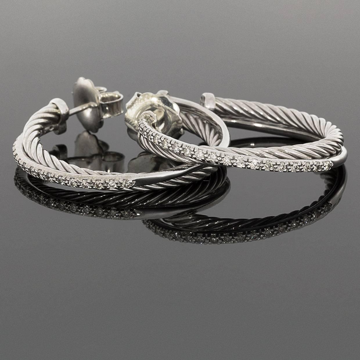 David Yurman's cable style jewelry has become his signature, the unifying element of every collection. These beautiful David Yurman Crossover Collection hoop earrings feature scintillating diamonds that have a combined total weight of .49 carat &