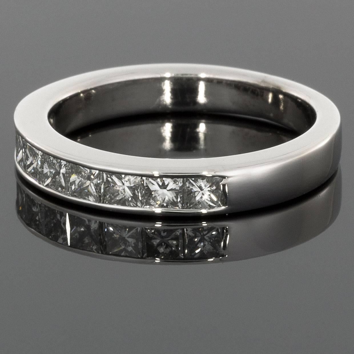 This classic band is a beautiful 14 karat white gold princess diamond channel band that can dress up any ring. It can be used as a wedding band, stand alone band, or stack ring. The ring has 9 princess cut diamonds that have a combined total weight