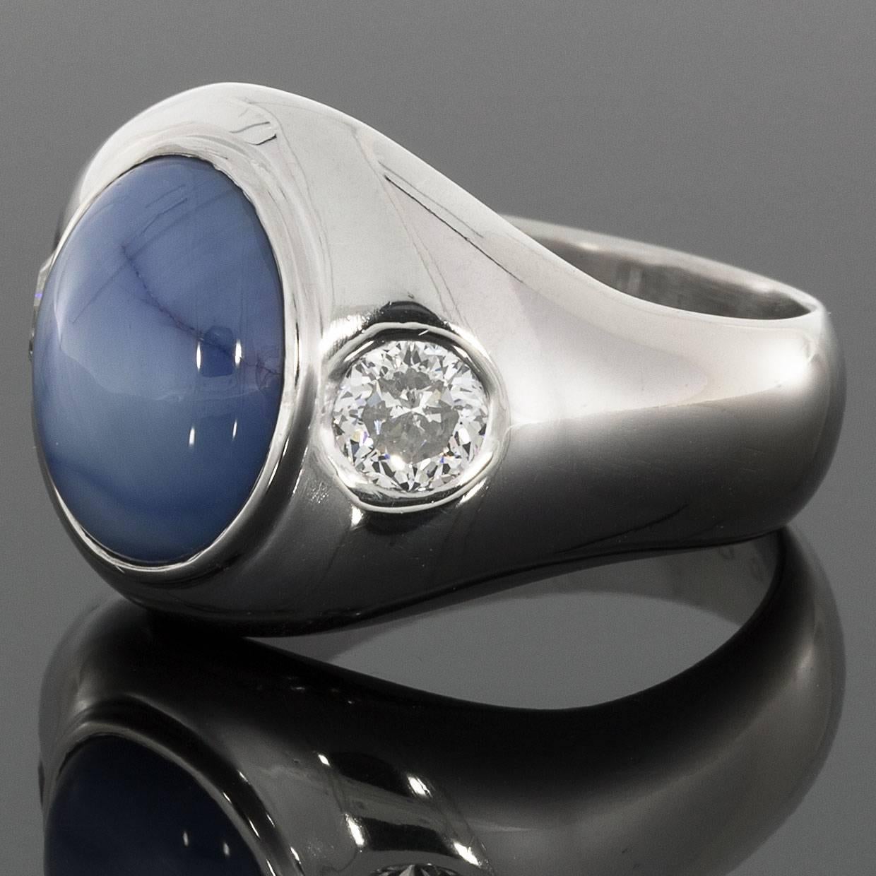 This awesome ring features an 8 carat, natural, oval cabochon cut, blue star sapphire. This gorgeous sapphire is bezel set in custom made, platinum gents ring. This ring also features 2 specialty, J.C. Millennium cut diamonds that have a combined
