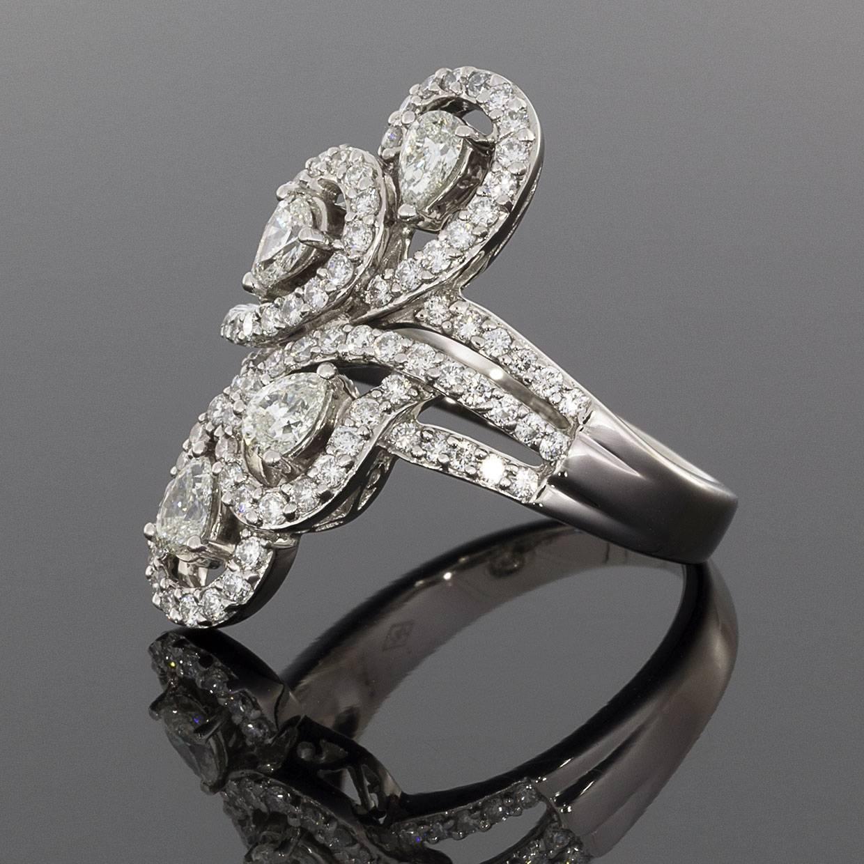 This gorgeous diamond fashion ring is sure to catch your eye from every angle! It features a 4 pear shaped diamonds surrounded by paisley shapes in 18 karat white gold. These scintillating diamonds are prong & pave set & have a combined total weight
