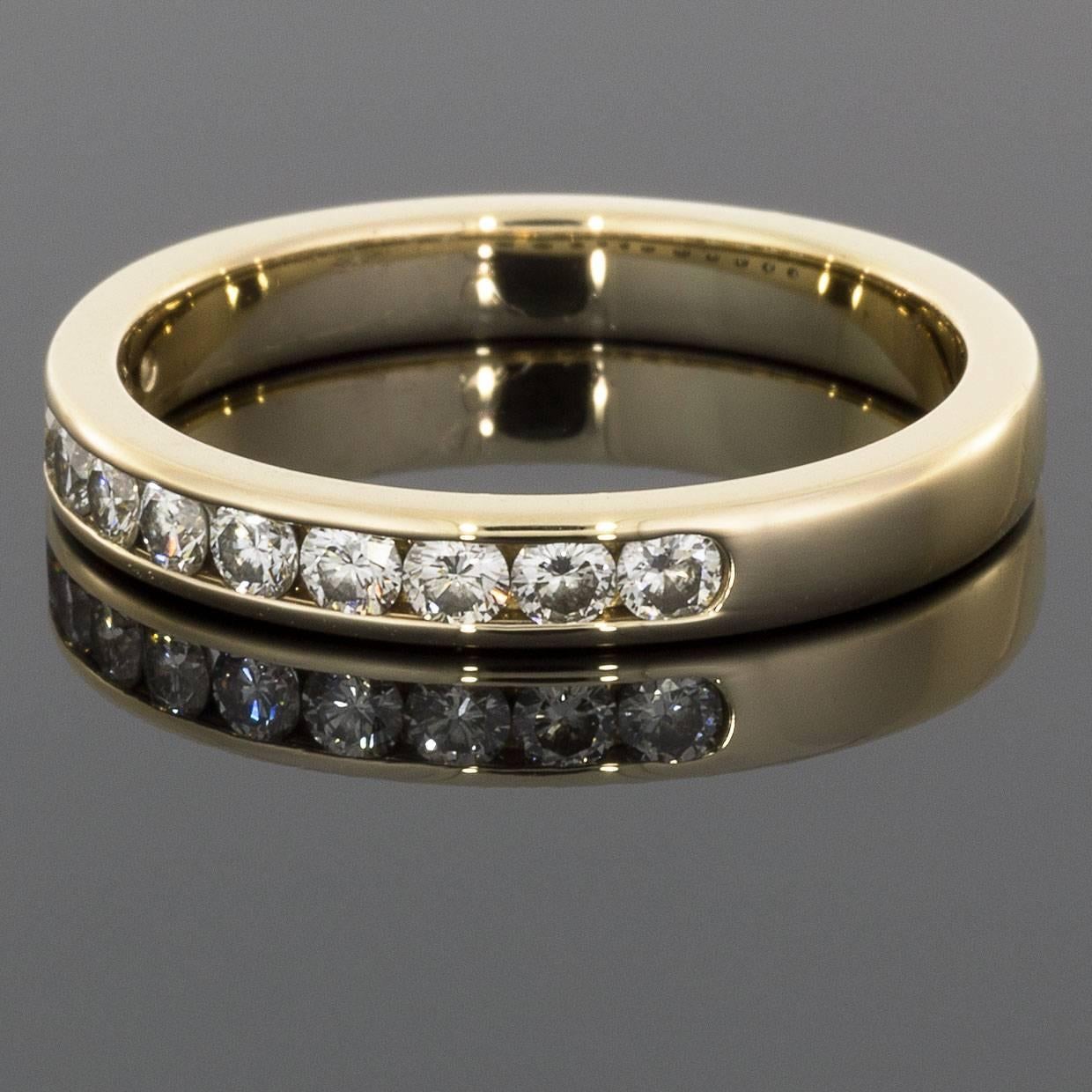 This classic band is a beautiful 14 karat yellow gold diamond band that can dress up any ring, stand alone, or stack with others. The ring features 11 round brilliant cut diamonds that have a combined total weight of .33 carats & grade as GH/SI1 in