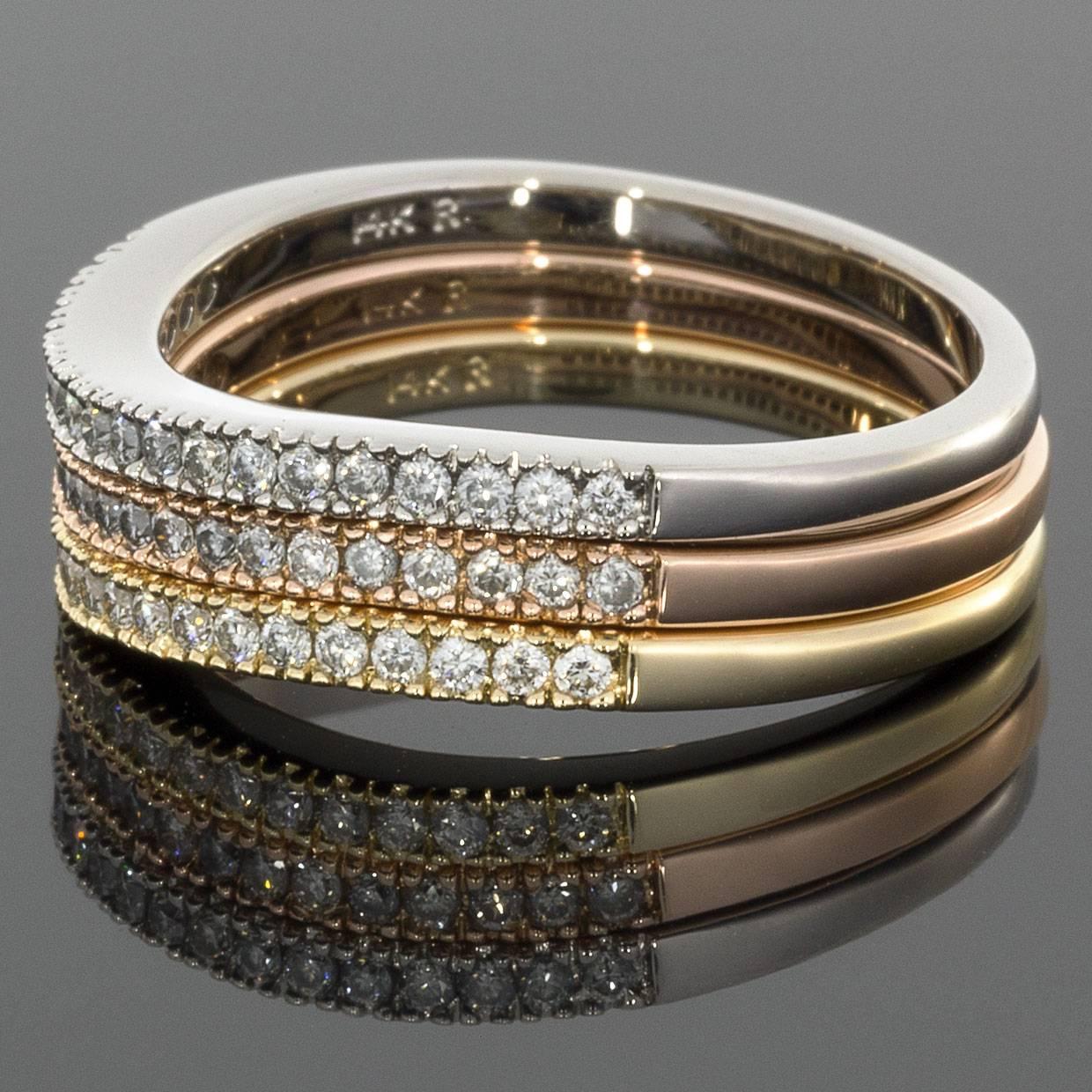 This unique 3 ring set has a beautiful wavy design in 14 karat tri-color gold & features just the right touch of sparkle! The diamonds in all 3 bands have a combined total weight of .50 carat & grade as HI/SI in quality. Comprised of 14 karat
