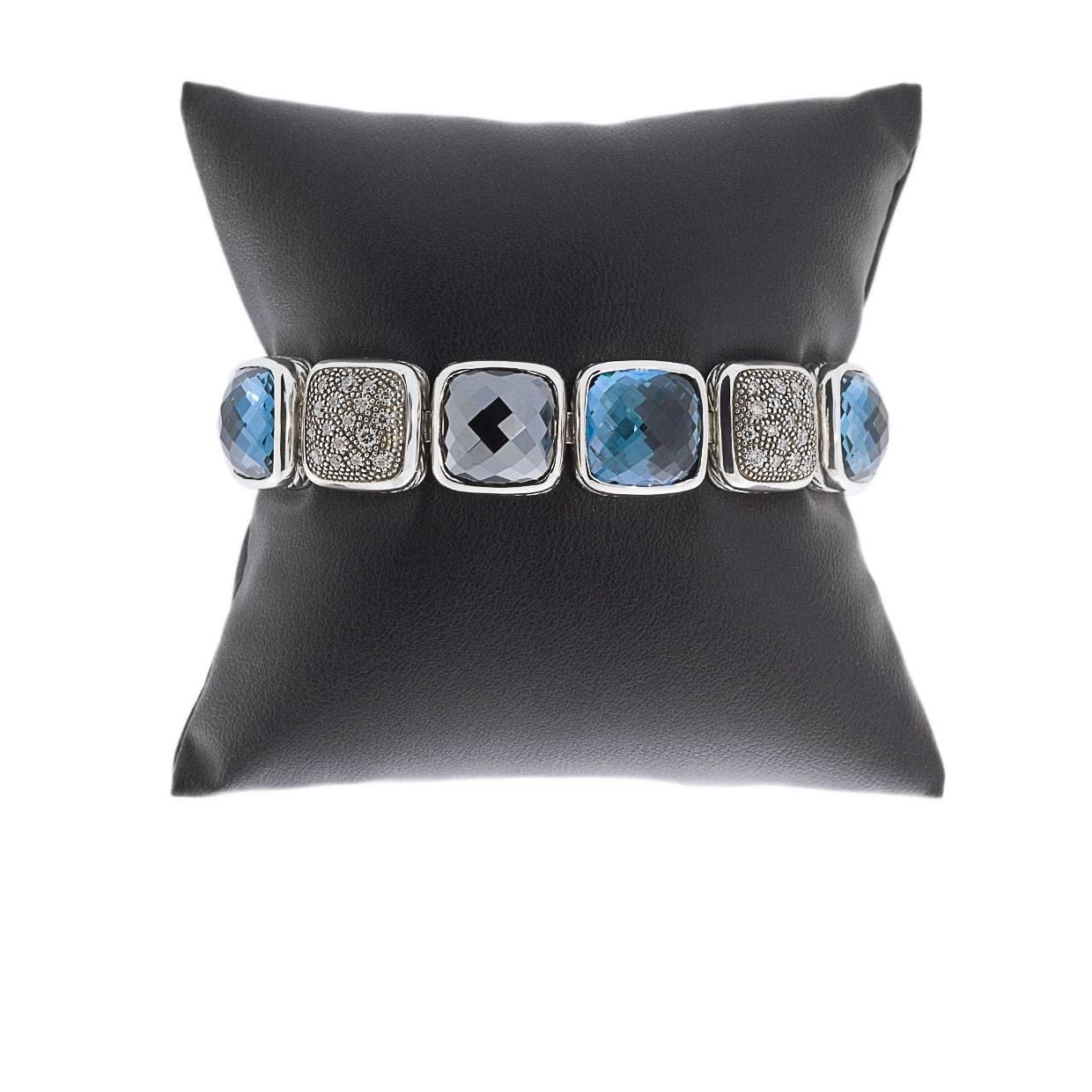 This beautiful David Yurman bracelet is from the Cushion on Point Collection. The bracelet features three cushion cut square blue topaz gemstones and two black cushion cut square hematite gemstones measuring 12 x 12 mm. 

Two squares of the bracelet