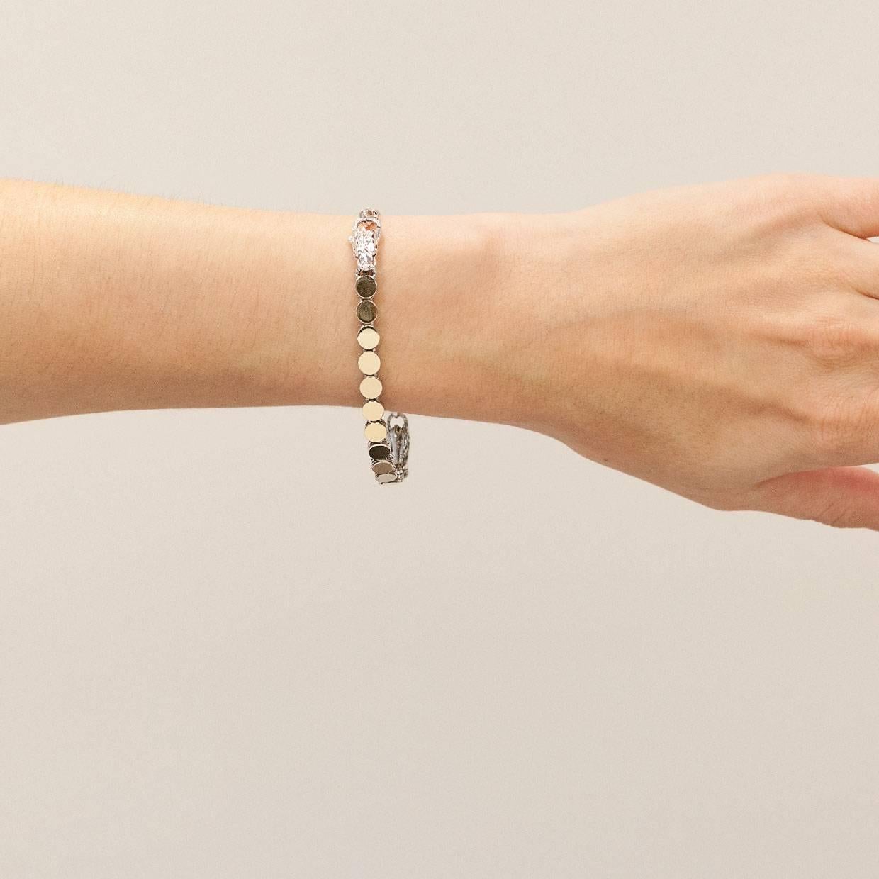 Each piece of John Hardy jewelry has been crafted in Bali since 1975. John Hardy is dedicated to creating timeless one-of-a-kind pieces that are brilliantly alive.

This silver and gold bracelet is from John Hardy's Batu Dot Dragon collection. The