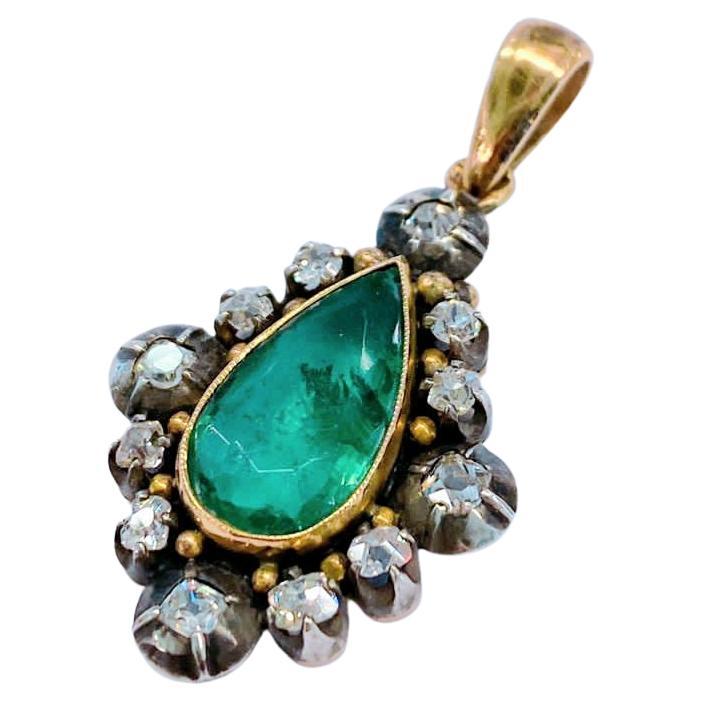 Antique Russian natural emerald pendant made by important faberge workmaster abraham beilin centered with pear shape green emerald messurments of 14.40mm×8.90mm inclusions included flanked with old mine cut diamonds pendant length 3.5cm hall marked