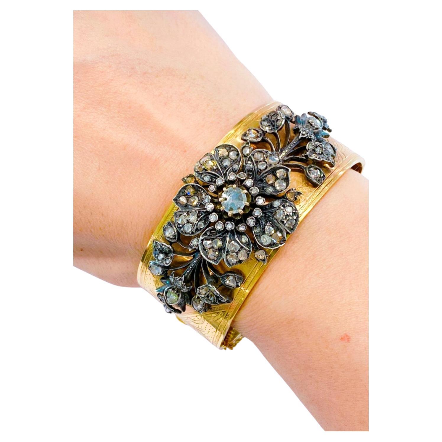 Antique French rose cut diamond cuff bracelet with an estimate diamond weight of 3 carats centered with 1 rose cut diamond of 0.80 carat back foiled and total 18k gold weight of 40 grams decorated on top with silver floral work design hall marked