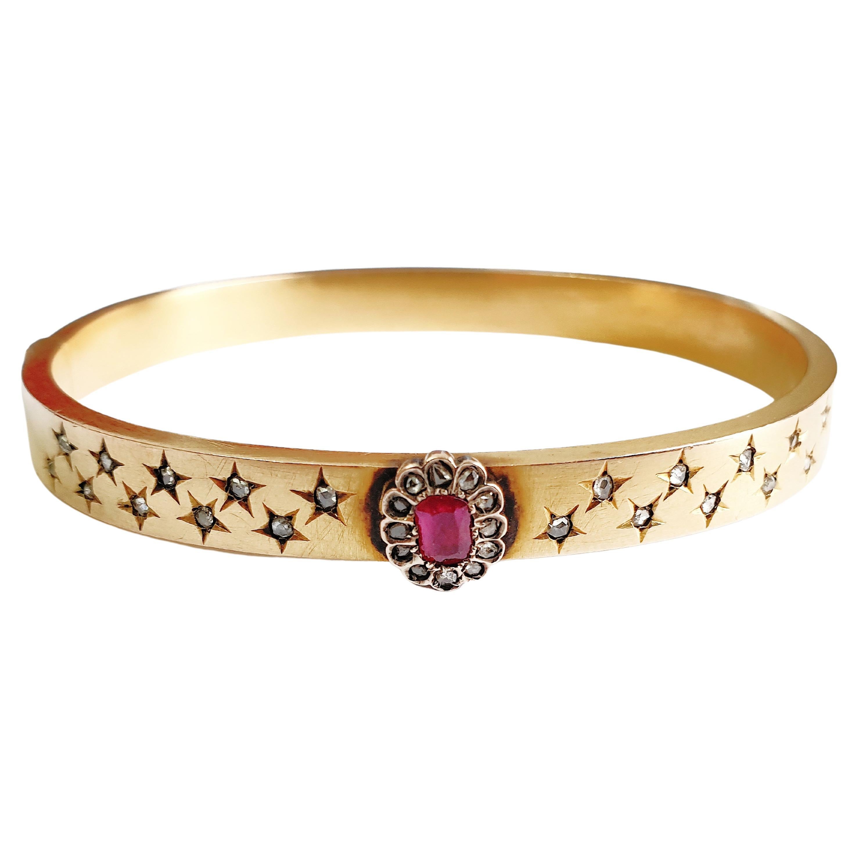 Antique Russian cuff bracelet centered with oval cut ruby stone fl with rose cut diamonds in star shape prongs and mat yellow gold colour hall marked 56 imperial Russian gold standard and st Petersburg assay mark before 1899.c and initial maker mark