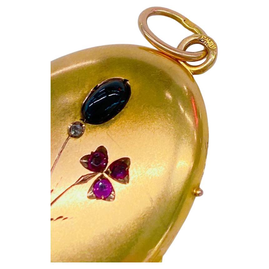 Antique Russian locket pendant in artnoveo floral design on front with blue cobouchon sapphire and rubies 5cm length pendant hall marked 56 imperial Russian gold standard and assay mark dates back to 1900/1904.c 