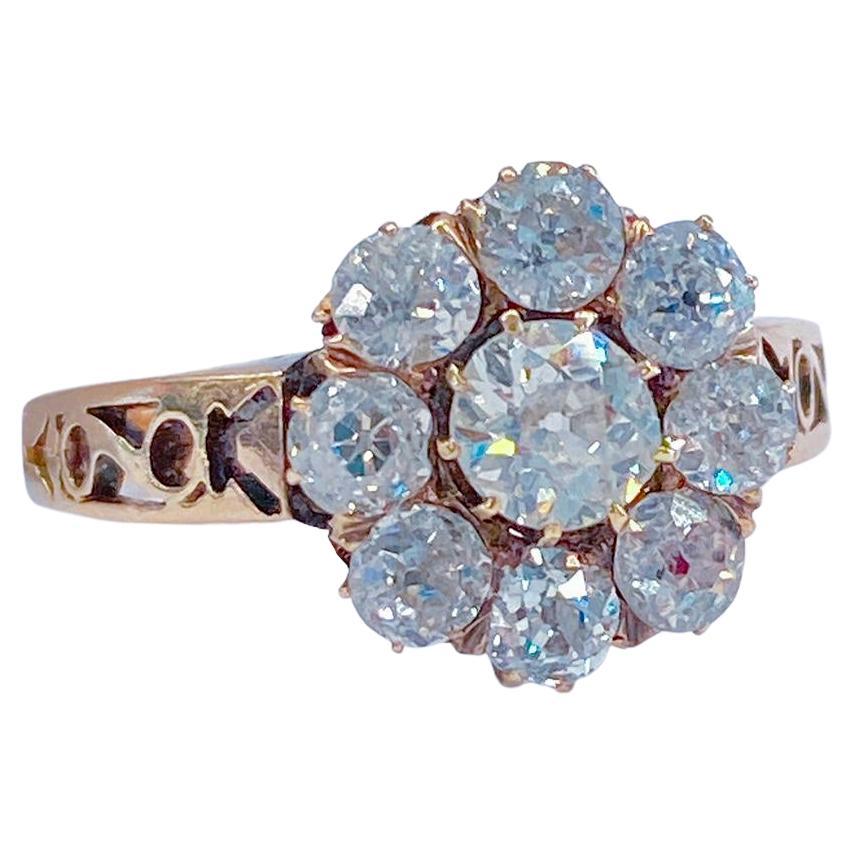 Antique old mine cut diamond ring in floral design centered with 1 old mine cut diamond estimate weight of 0.35 carats flanked with smaller old mine cut diamonds estimate weight of 1.35 carats H color white excellent spark with open work design on