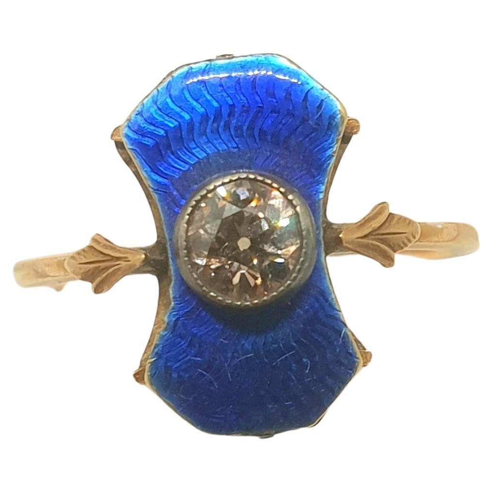 Antique Russian blue guilloche enamel ring centered with diamond  diameter of 5mm estimate weight of 0.50 carats brownish colour ring head diameter 9mm ring size 6.5 us chart hall marked with initial maker mark in cyrillic alphabet and later 583