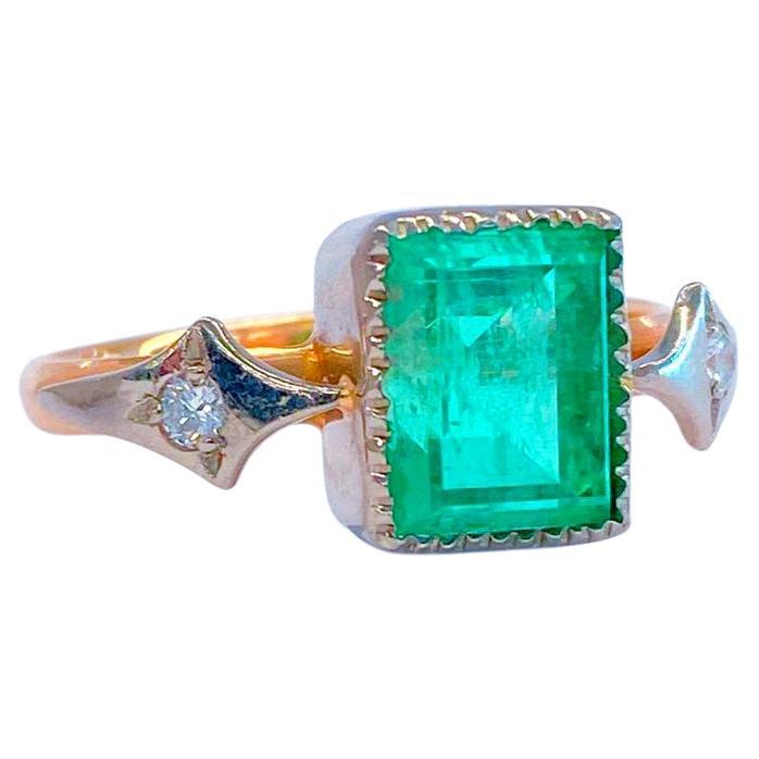 Vintage lab created russian Emerald solitaire ring centered with 1 large green emerald in emerald cut with estimate emerald weight of 3.85 carats flanked with 2 smaller diamonds old cut diamonds in 14k rose gold and white gold setting emerald