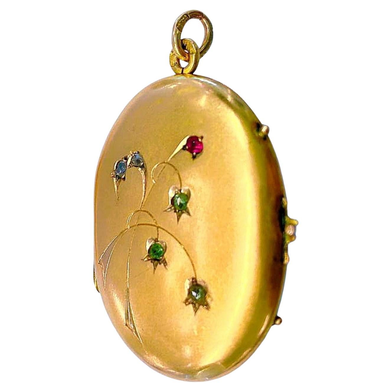 Antique 14k gold russian locket pendant engraved on front with art nouveau style flower with green demantoid stones and rose cut diamonds and ruby pendant is hall marked 56 imperial russian gold standard and initial maker mark in cyrillic alphabet
