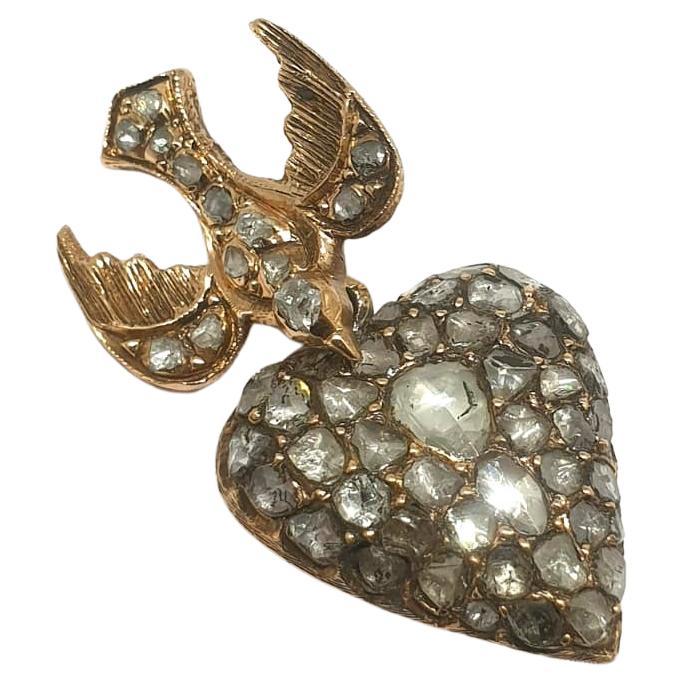 Antique victorian era heart pendant with rose cut diamonds hanging with a swallow bird in 10k gold back foiled diamonds estimate weight 1.5 carats pendant lenght 3.5cm was made 1880/1890.c 