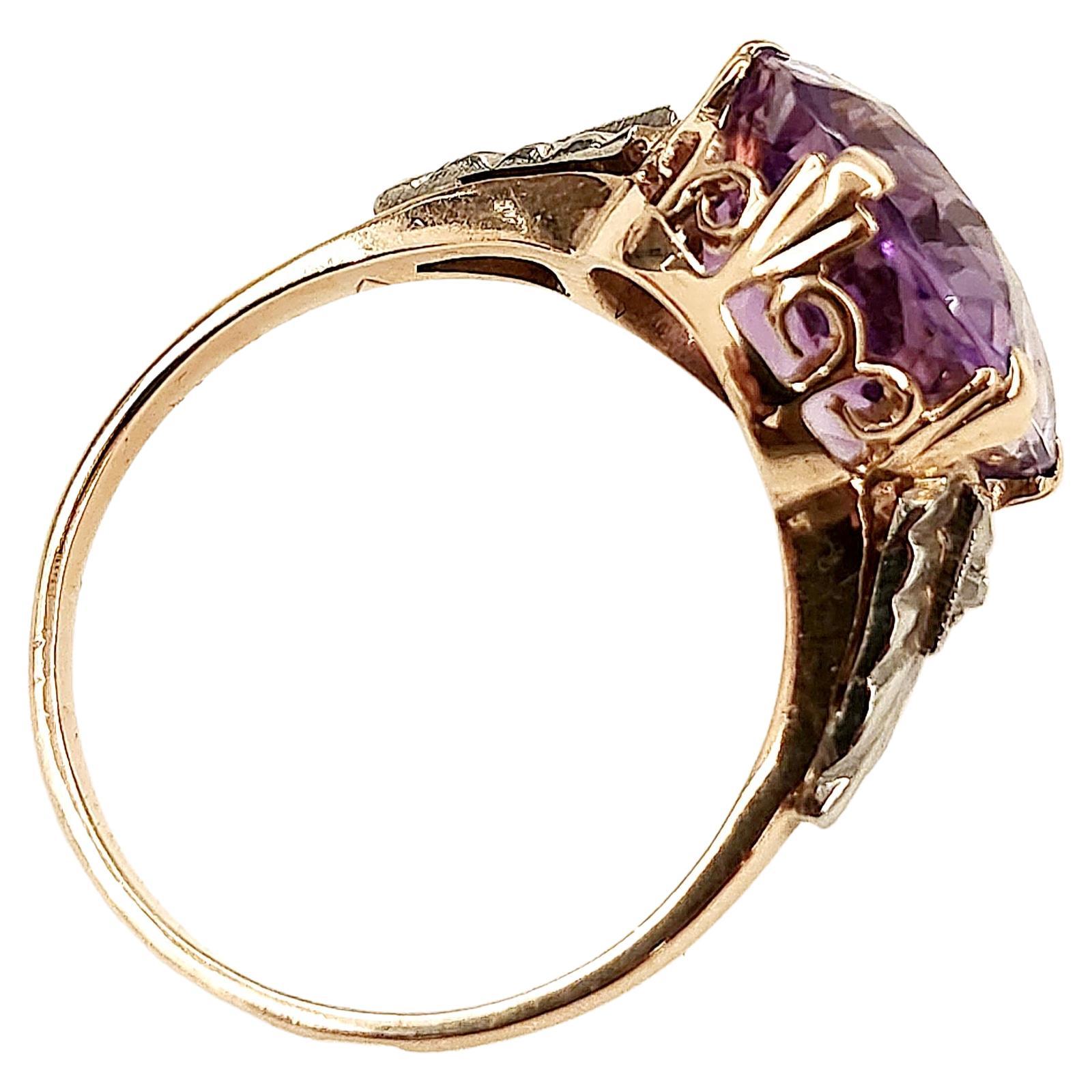 Vintage 14k gold solitare ring centered with natural large siberian amethyst in oval cut with a diamrter of 14.80mm×12.17mm with detailed work on ring sides ring was made in moscow during soviet union 1940/1950.c hall marked 583 for 14k gold and