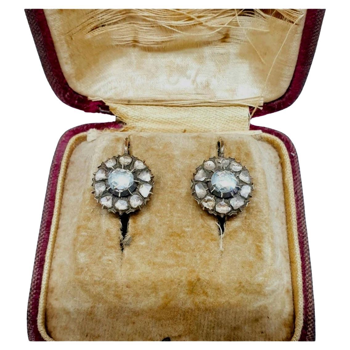 Antique victorian 10k gold rose cut diamond earrings centered with 1 large diamond flanked with smaller diamonds in detaled prongs with estimate weight of 1.5 carats back foiled dates back to 1880/1890.c