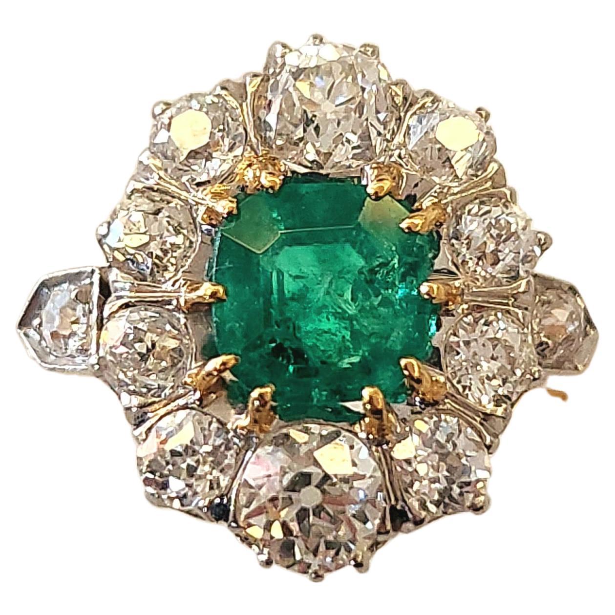 Antique 18k gold french ring centered with natural green colombian emerald with a diameter of 6mm×6.14mm flanked with old mine cut diamonds estimate weight 2.55 ct H colour vs clearity excellent spark  ring is hall marked with french eagle head gold