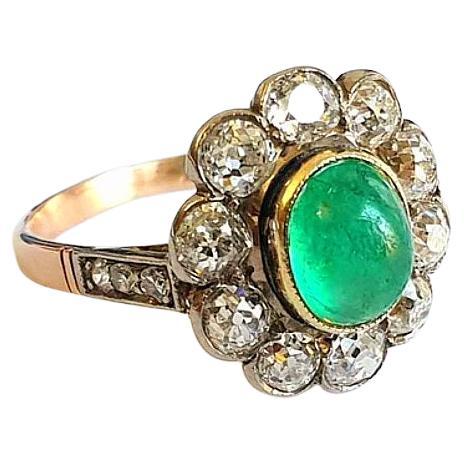 Antique 14k gold ring centered with green cabochon emerald in oval cut diameter 8.50mm flanked with old mine cut diaminds estimate weight of 1.5 carats ring was made during soviet era 1930.c 