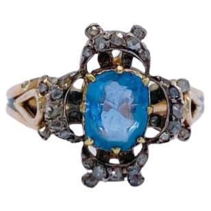 Antique 14k gold ring centered with 1 natural sky blue sapphire stone with a diameter 6mm×6.75mm flanked with little rose cut diamonds in detailed prongs workmanship ring was made in europe 1850/1880.c 