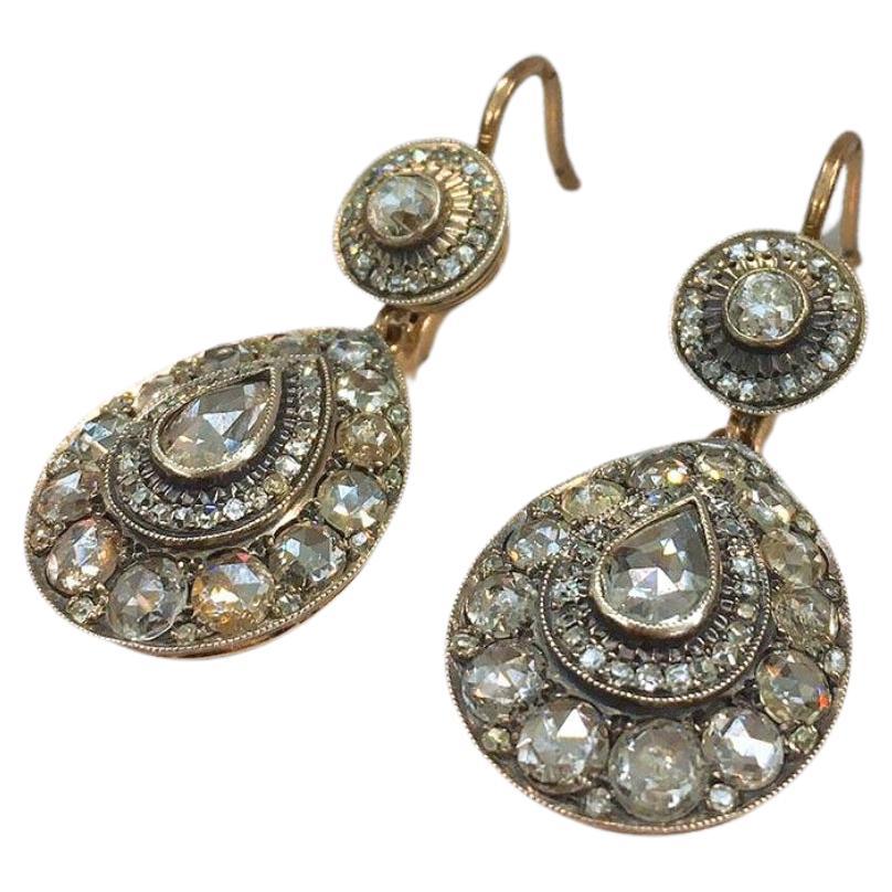 14k gold large dangling earrings in antique style centered with pear shape rose cut diamond flanked with large old mine cut diamonds with estimate total diamonds weight of 8 carats excellent spark 