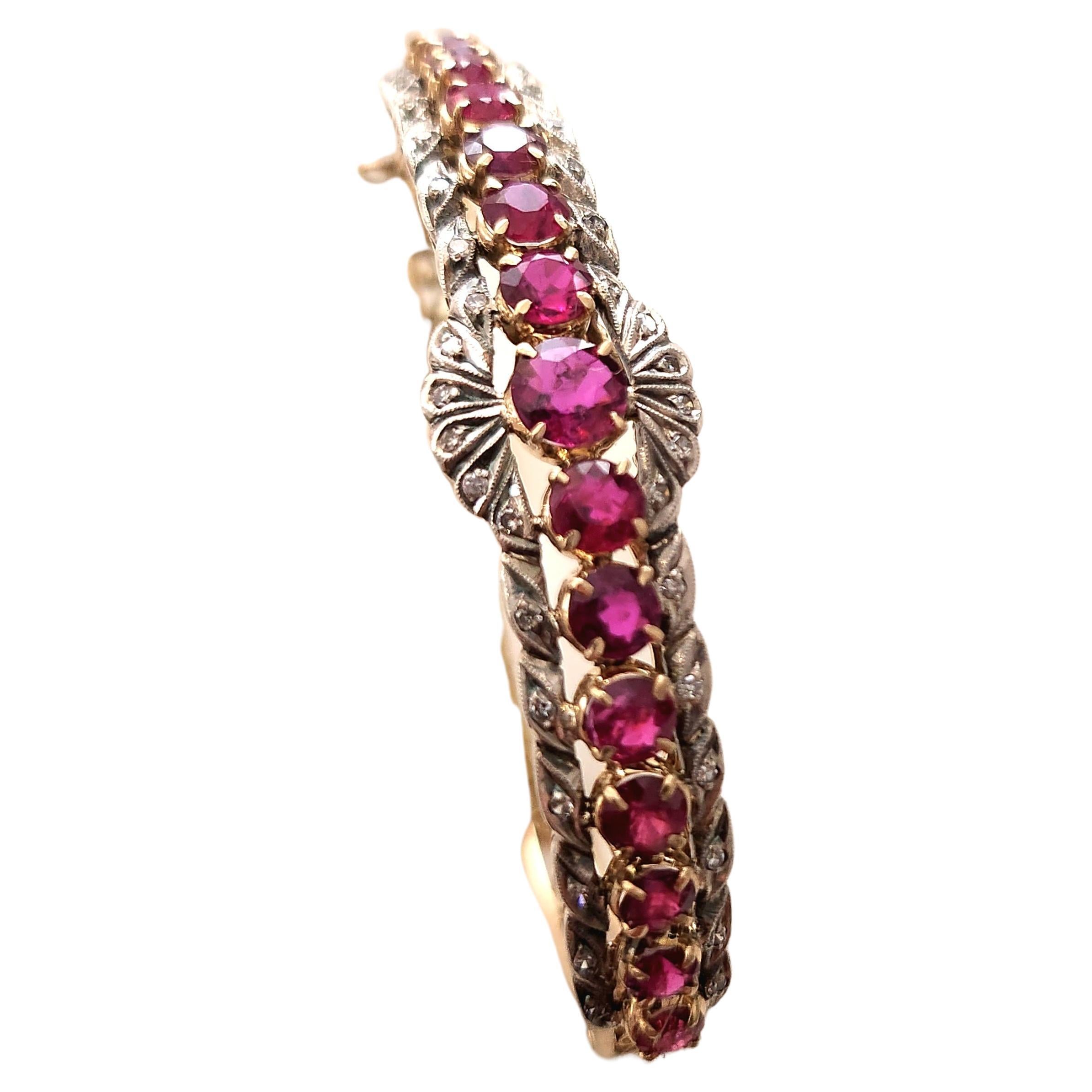 Antique ruby burmise orgine pigion blood color bangel bracelet with an estimate weight of 4 carats flanked with small diamonds in 14k gold open work style on bracelet sides bracelet width 6cm hall marked 56 imperial russian gold standard 