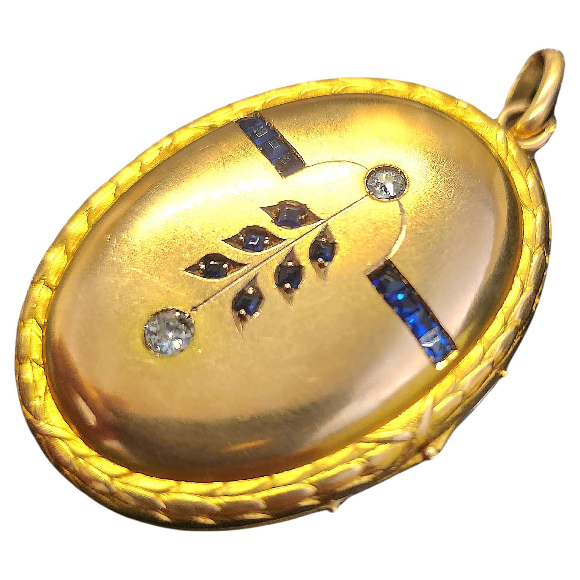 Antique locket 14k gold pendant in 2 tone color rose gold and yellow gold centered with 2 old mine cut diamonds decorted with natural baguet cut blue sapphires pendant lenght 5cm dates back to 1900/1910s during the imperial russian era hall marked