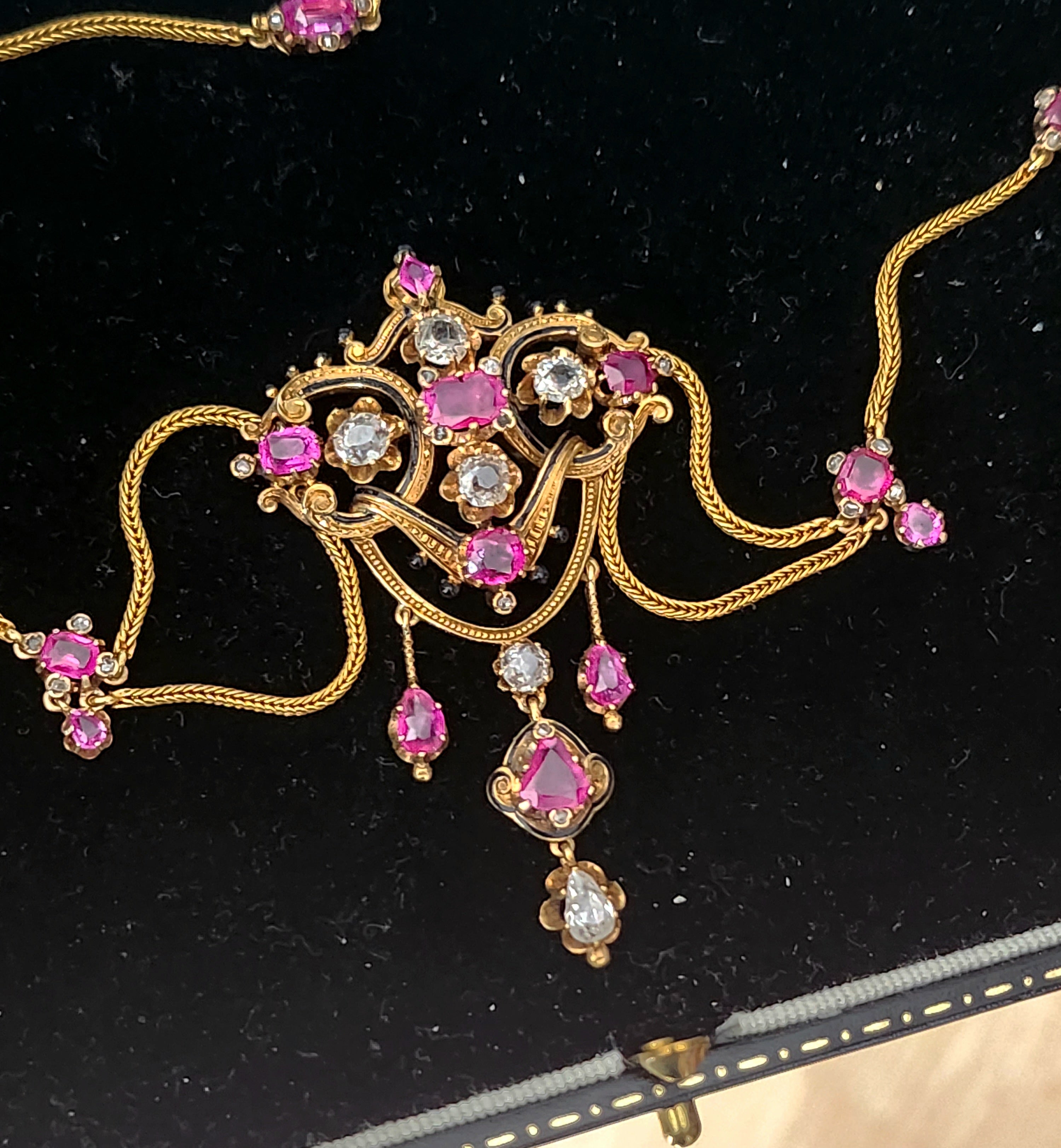 Antique 19th century art nouveau necklace in 18k gold with an estimate natural rubies of 6 carats and old mine cut diamonds 3.5 carats white color no inclousions decorted with black enamel in excellent condition