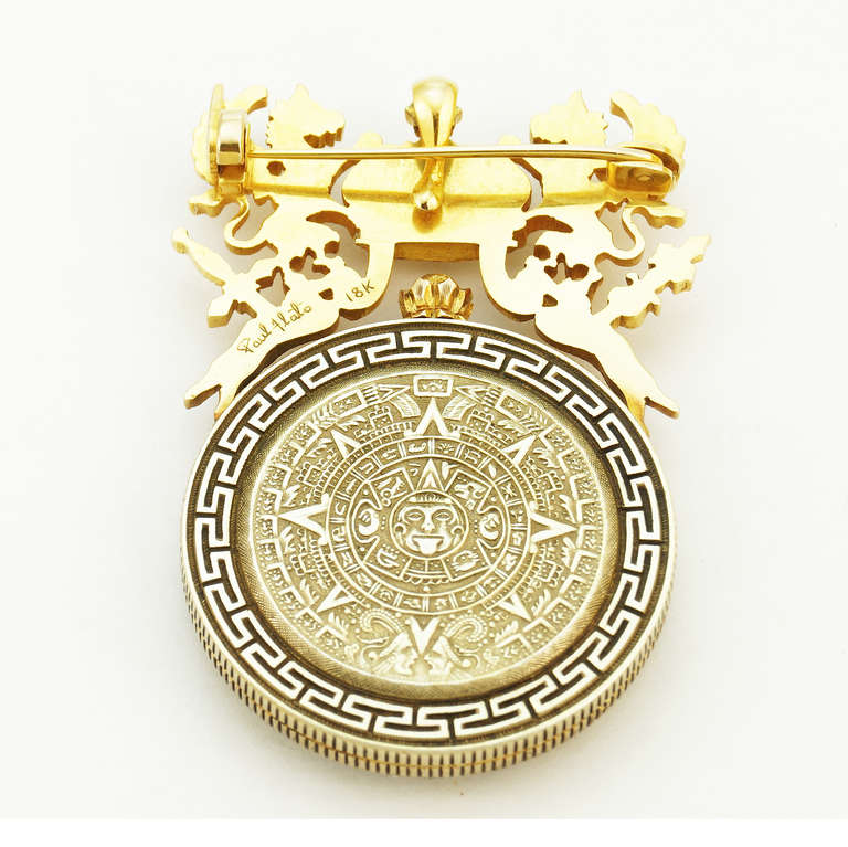 Paul Flato 18k yellow gold pocket watch with openwork dial cut from an antique peso crested with the Mexican Imperial Coat of Arms, circa 1950s, locking pin back with pendant hook, signed Paul Flato, 18k.