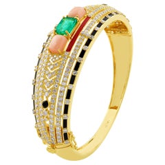 Armreif aus 18 Karat Gelbgold mit schwarzem Onyx, Koralle und Smaragd und Diamantschmuck