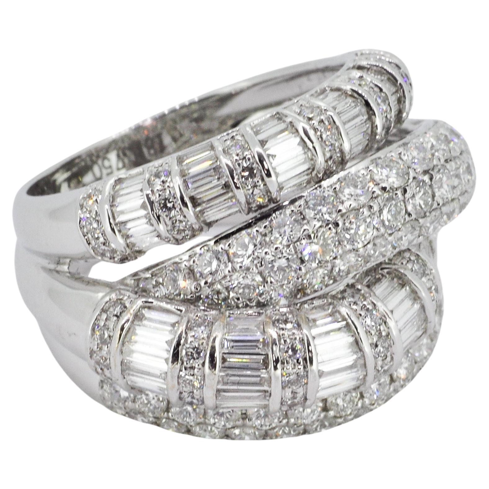 This statement-making white gold ring is a true testament to the artistry of jewelry design. Crafted from 18k white gold, it features bold settings of round and baguette diamonds that impart light-catching sparkle from every angle. With a total