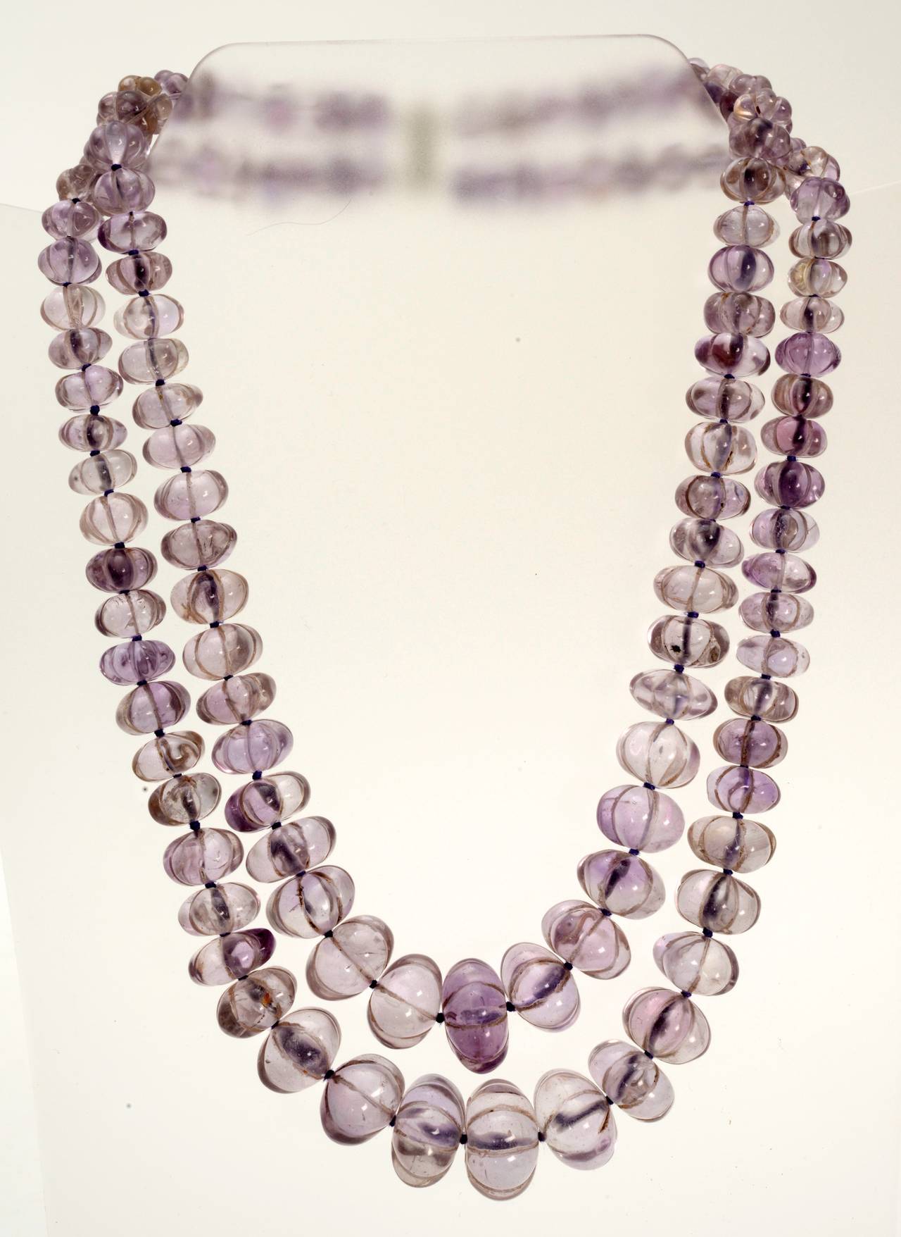 A spectacular double strand hand-carved amethyst bead necklace. Bead sizes range from 3/8