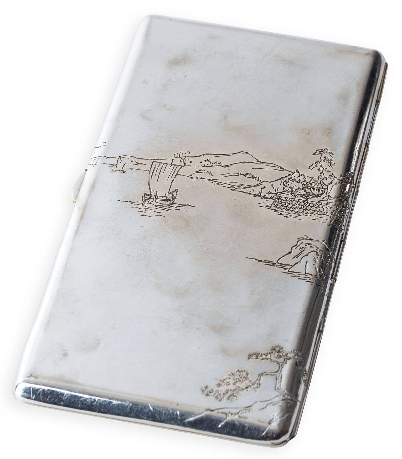 Japanese incised sterling silver scenic cigarette case. The design has applied oxidized copper over silver with gold highlights. The case demonstrates the Japanese ability to combine different metals on silver. Silver spring loaded chain keeps