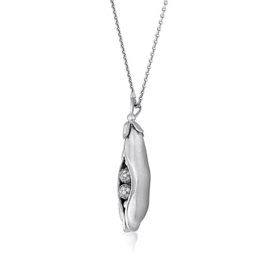Harry Winston Two Peas in a Pod Necklace.
The pendant is 18K White Gold with a Satin Finish.
The pod has 
