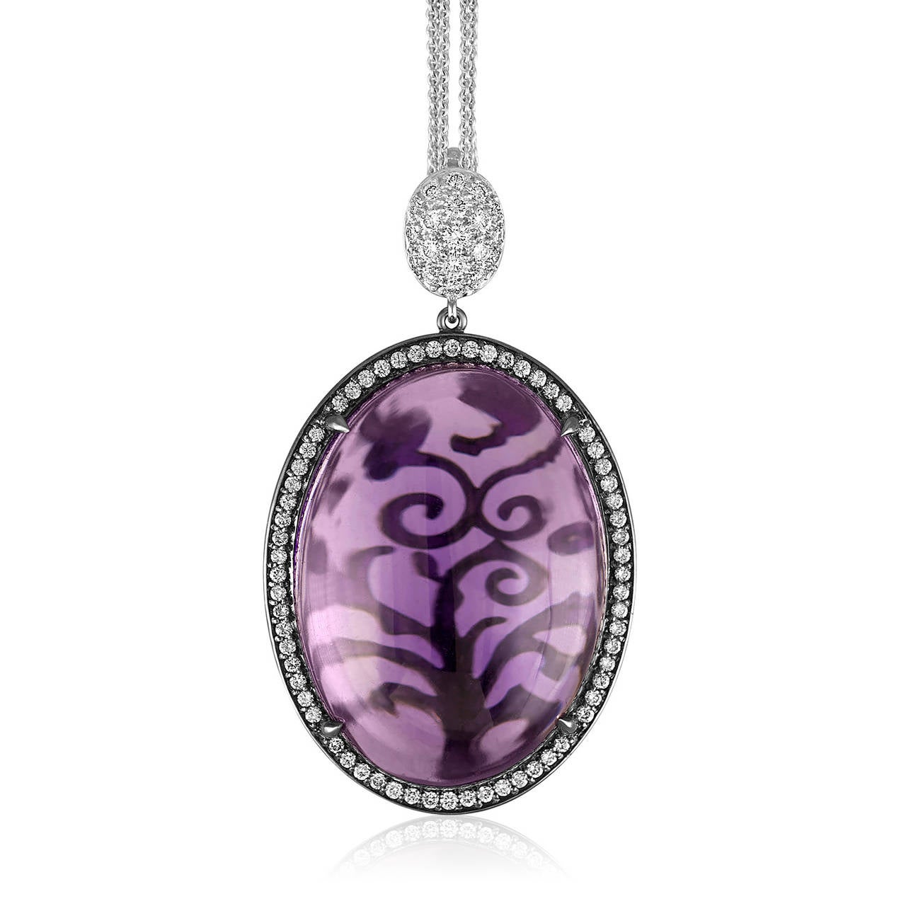 Amethyst Cabochon set in 18K White Gold.
The bail is PLT950 covered in diamonds
Beautiful Scroll Pattern can be seen through the Amethyst Stone.
Comes with 16