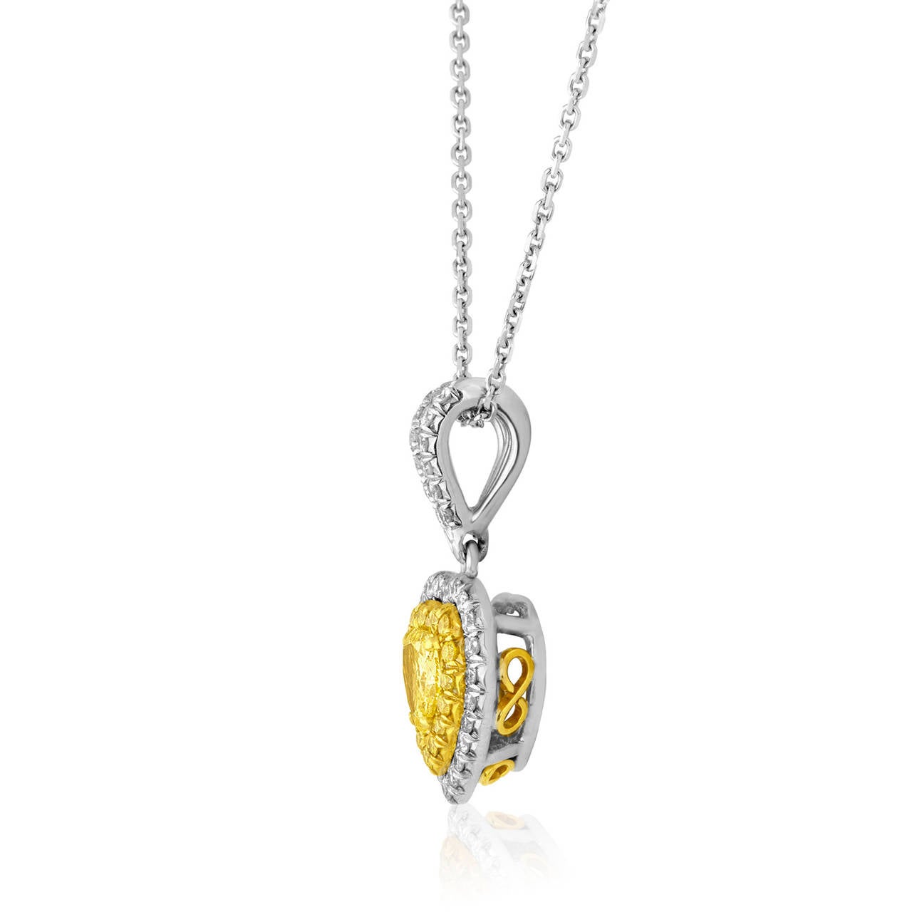 Beautiful Hand Made Necklace.
The pendant is 18K yellow and white gold.
The center stone is a FANCY INTENSE YELLOW 0.40 Carat Heart Cut Diamond VS.
The stone is surrounded by Fancy Yellow Diamonds 0.13ct VS.
There second row is 0.28 carat in white