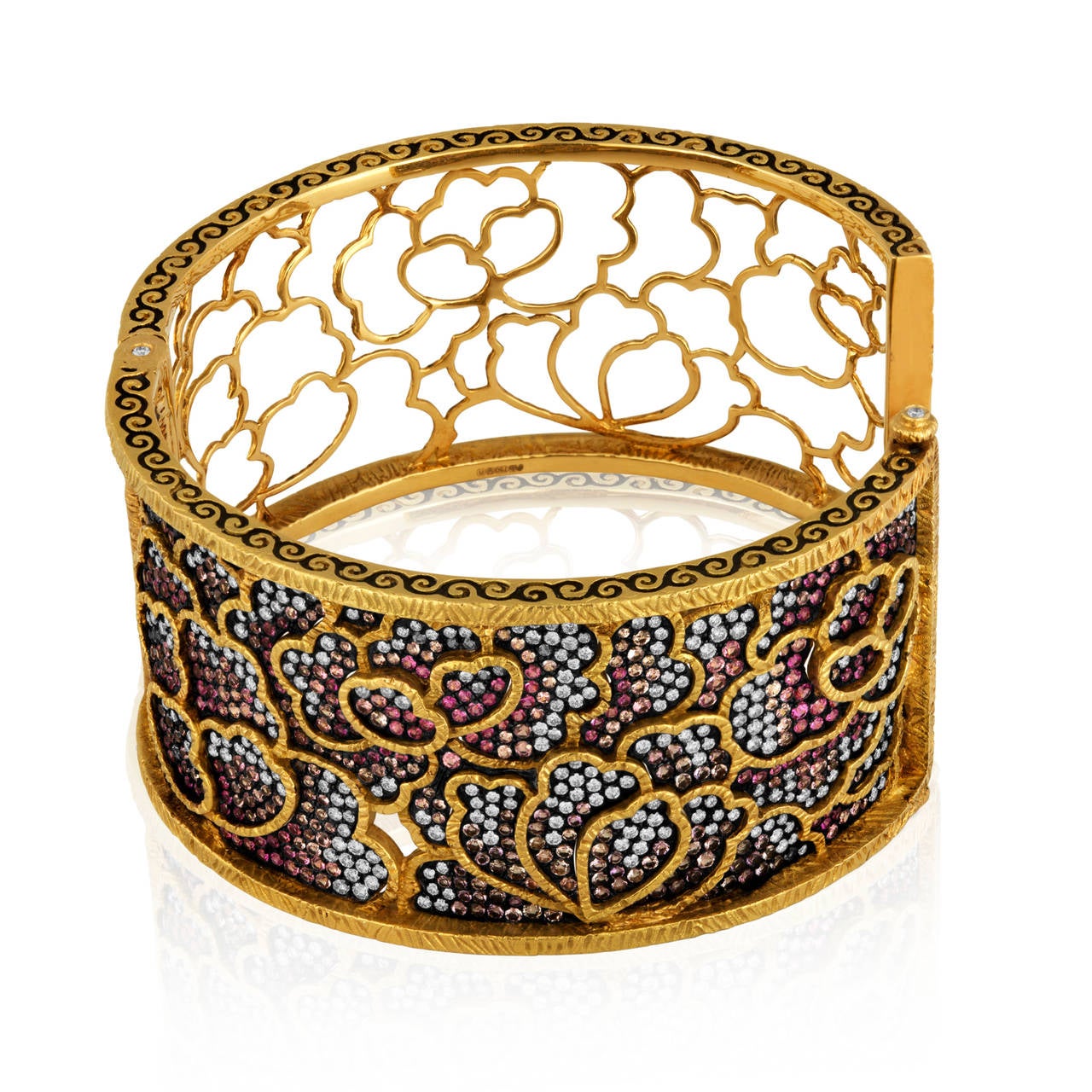 Dickson Yewn Cloisonne Collection.
The Bangle is 18K Yellow Gold.
There are 4.50 Carats in Diamonds F VS.
There are 5.00 Carats in Pink Sapphires.
There are 5.00 Carats in Amethyst.
The bangle weighs 96.7 grams.
The bangle is 1.25