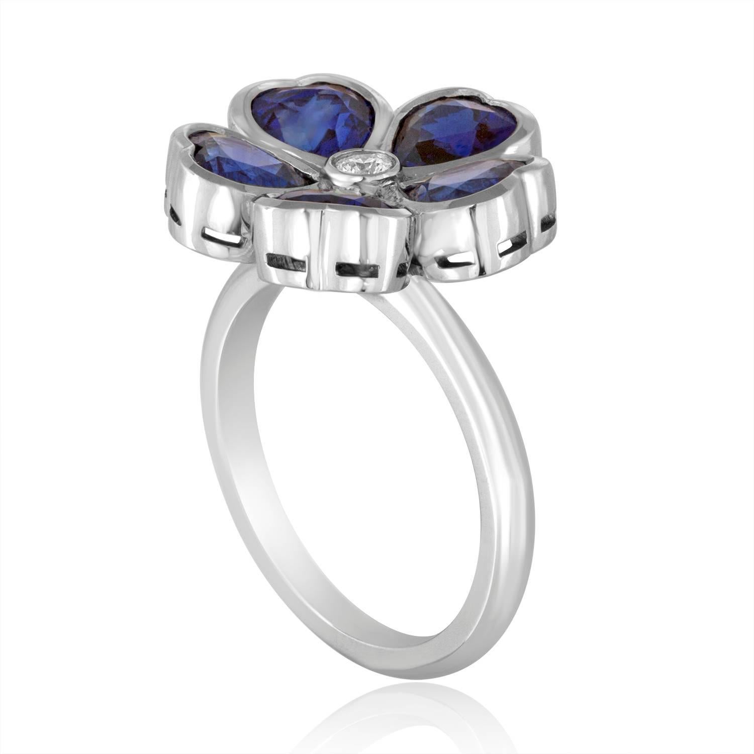 Custom Made and Master Crafted Sapphire Flower Ring
5 Heart Shaped Sapphires petaled around One Round Cut Diamond
The ring is 18K White Gold
There are 3.92 Carats Blue Sapphires Heart Shaped
There is 0.05 Carat Diamond F VS
The flower portion is