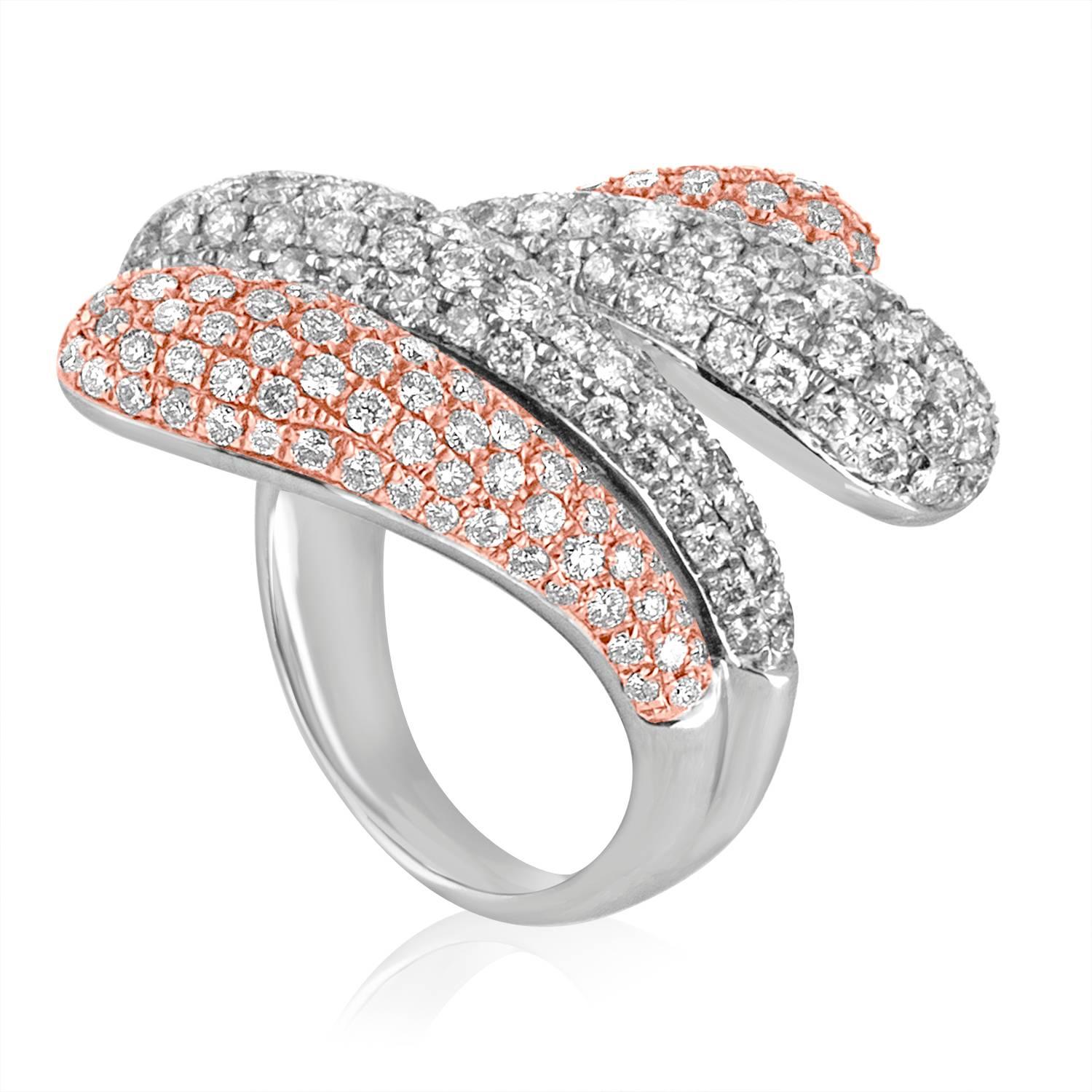 Beautiful Bypass Ring
The ring is 18K White & Rose Gold
There are 3.28 Carats in Diamonds F/G VS/SI
The ring measures 1 2/16