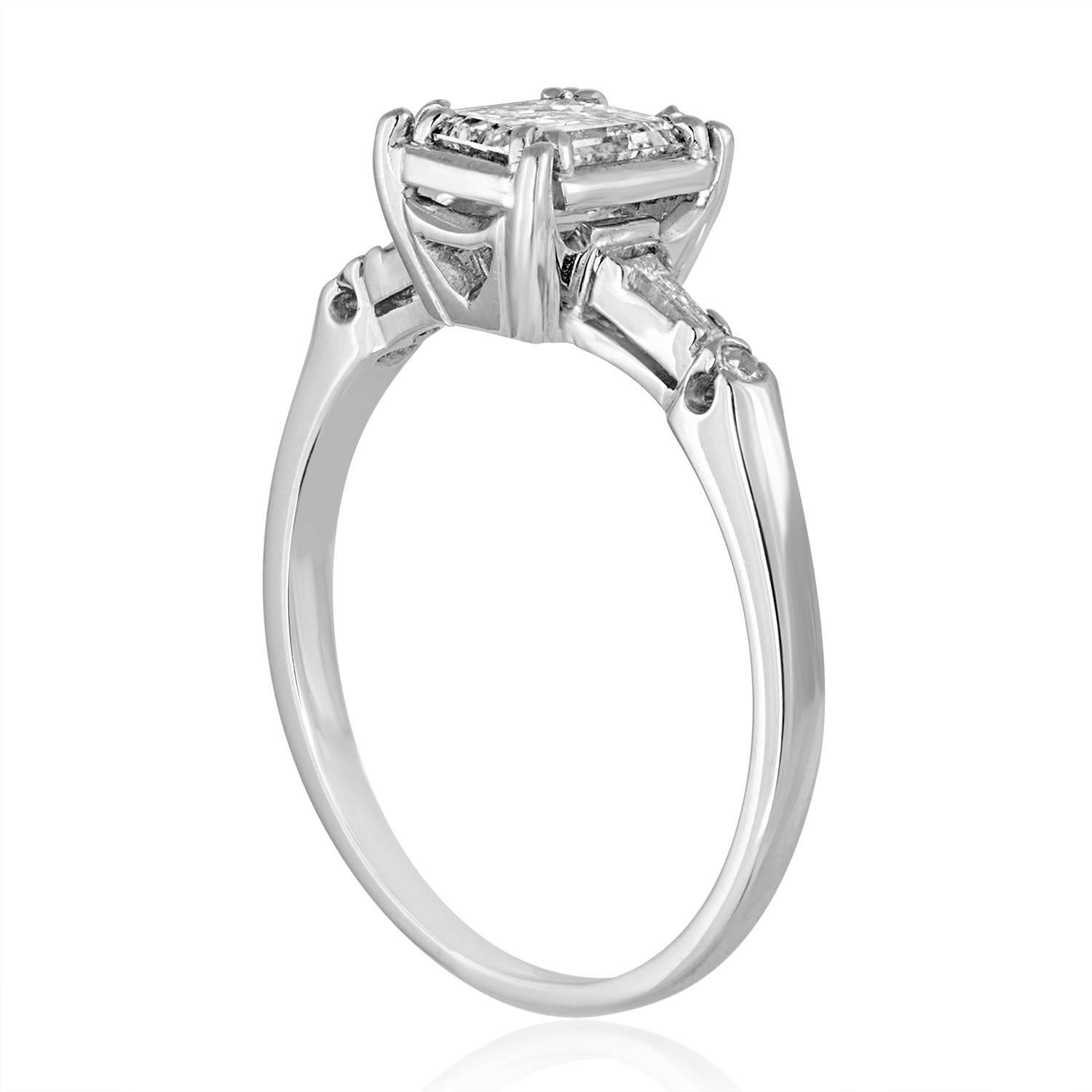 Beautiful & Delicate Engagement Ring.
The ring is Platinum.
The center stone is Emerald Cut 0.71Ct G/H VS2/SI1
On the sides are tapered baguettes and small round diamonds 0.11Ct G/H VS2/SI1
The ring is a size 6.5, sizable.
The ring weighs 3.8