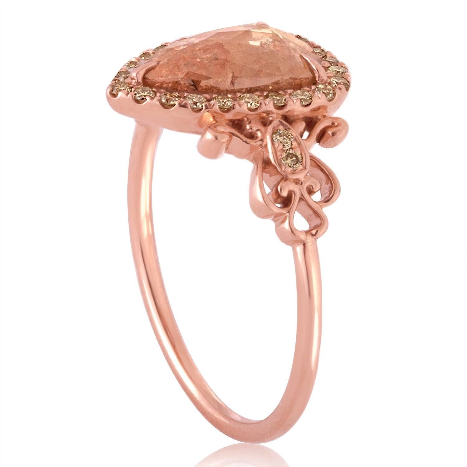 Very Delicate and Fun Ring
The ring is 14K Rose Gold
The center stone is a Pear Shape Diamond Slice about 0.70 Carats.
The pear shape is a Brownish-Orange-Silver Color.
The small Diamonds are Yellowish-Silver about 0.25 Carats
Any imperfections in