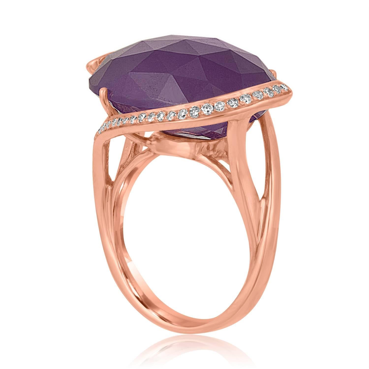 Beautiful and Fashionable Purple Colored Jade Ring
The ring is 14K Rose Gold
The Oval Purple Jade is 24.85 Carats
There are 0.16 Carats in Diamonds G/H SI
The top of the ring measures 1