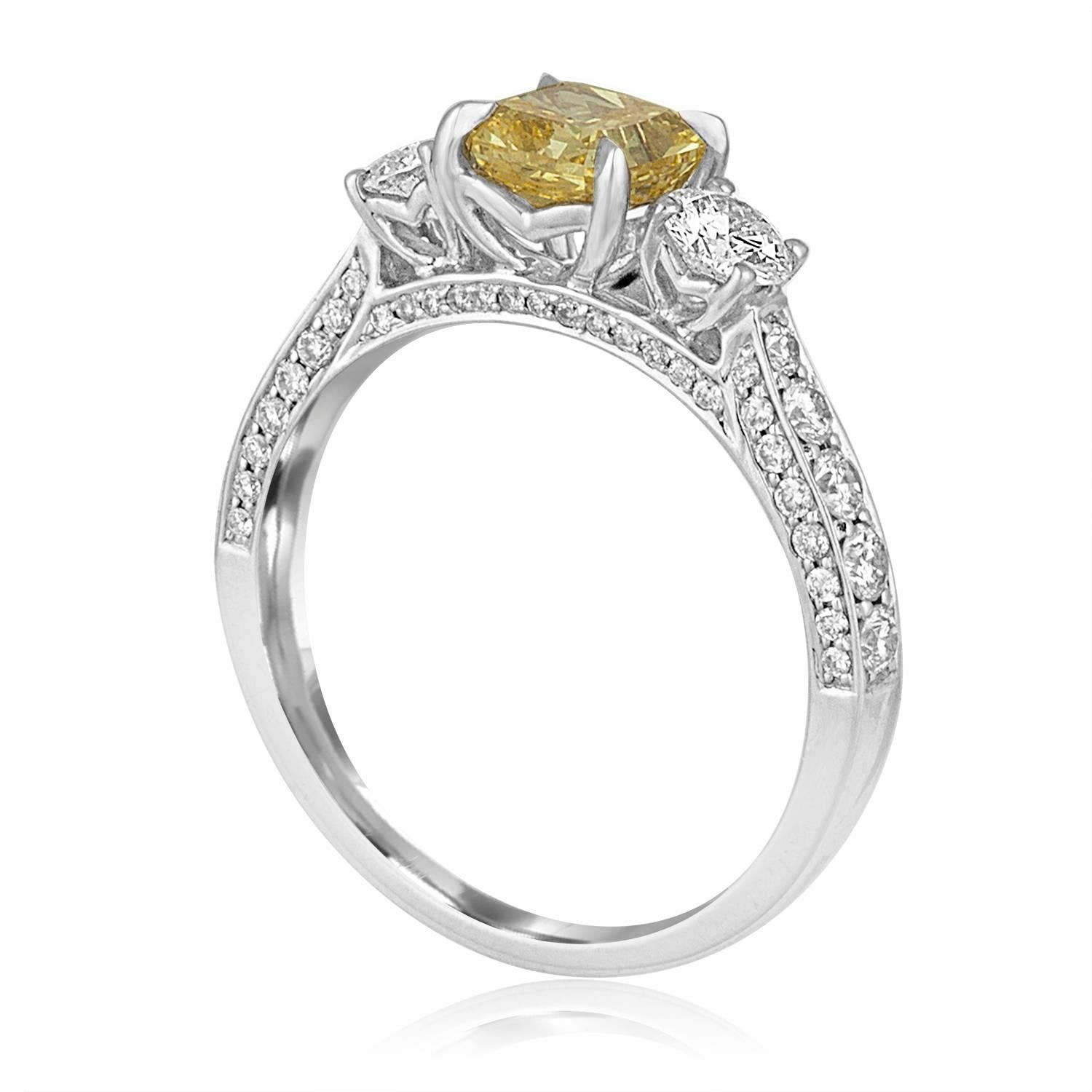 Stunning 3 Stone Engagement Ring
The ring is 14K White Gold
The center stone is GIA Certified Diamond
The stone is Radiant Cut Fancy Intense Yellow 0.91 Carat VS2
The side stones are 0.34 Carats F SI
There are small stones on the band 0.43 Carats F